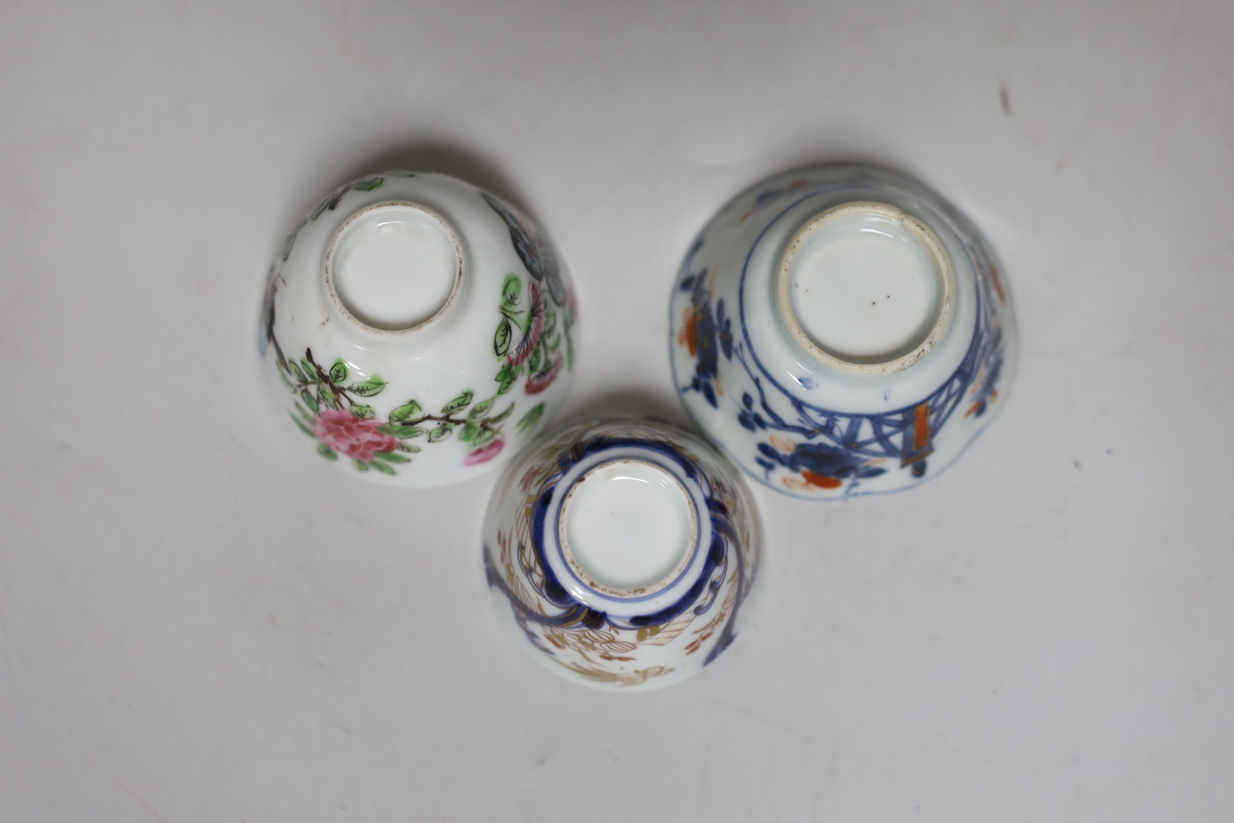 An English porcelain blue and white slop bowl, 15cm diameter, together with three miniature Chinese tea bowls and one nail guard